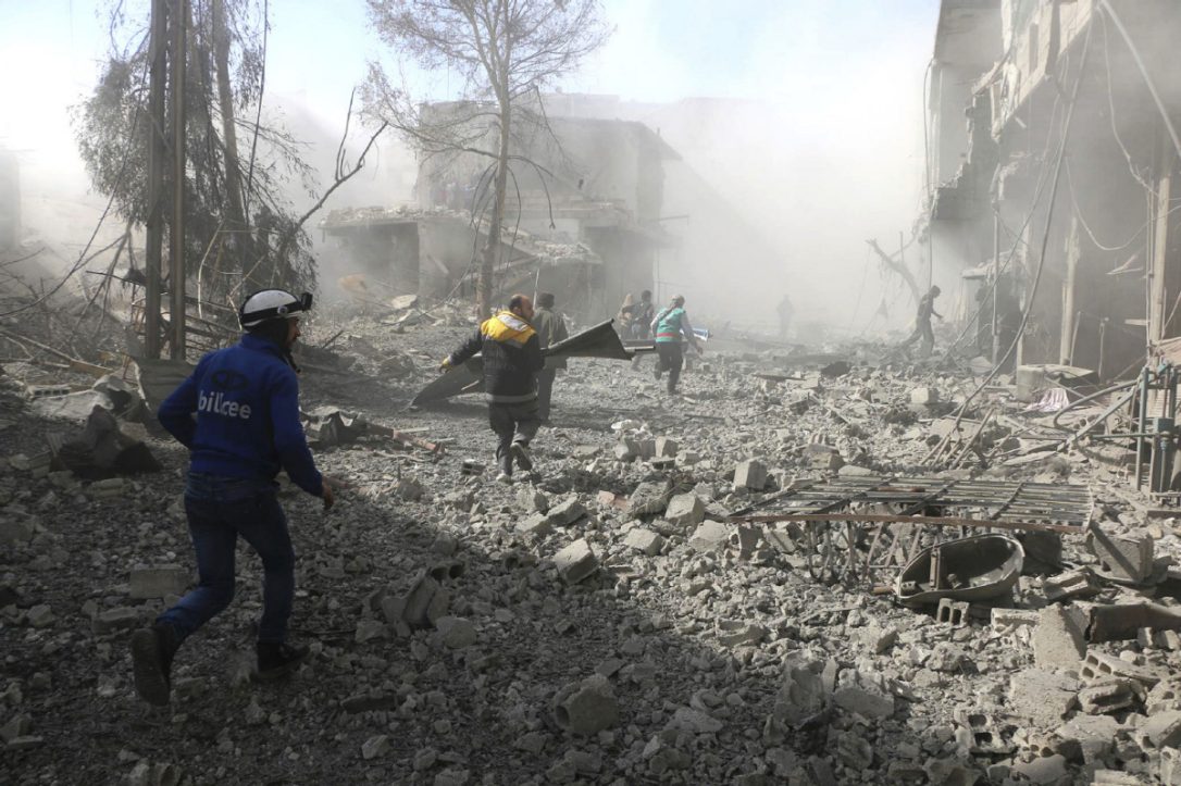 White Helmet members of the Syrian Civil Defence run to help survivors following airstrikes and shelling of the Syrian government forces in Ghouta, a suburb of Damascus, Syria, on Tuesday.