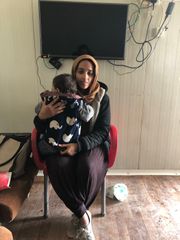 Hoda Muthana holds her 18-month-old son Adam inside a refugee camp in northern Syria, on March 28, 2019. 