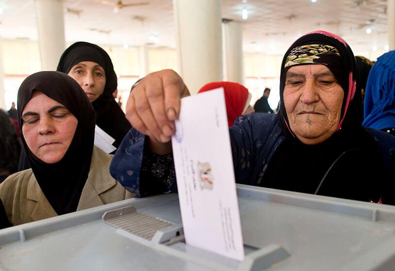 A Syrian woman votes at an electoral college during the Syrian parliamentary elections in Damascus, Syria, on 13 April 2016