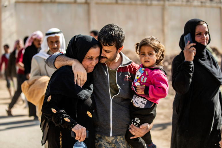 A man suspected of having collaborated with ISIL is greeted by family members upon his release from the Kurdish-run Alaya prison in the northeastern Syrian city of Qamishli [Delil Souleiman/AFP]