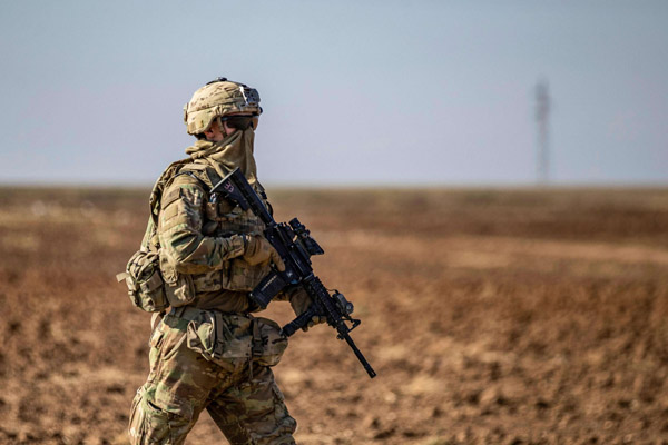  A US soldier patrols near the village of Tal Alo, in the Yarubiyah district of Syria’s northeastern Hasakah province near the M4 highway, last November. (AFP)